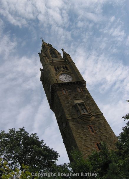Gothic tower against pebbledash blue sky