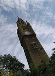 Gothic tower against pebbledash blue sky